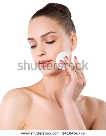 Beautiful woman cleaning the face. Isolated female portrait. Beauty treatment Royalty-Free Stock Photo #1418466776
