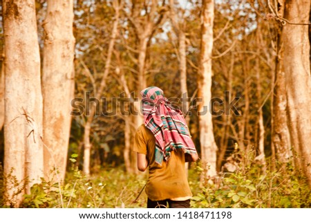 Young cowboy walking around a forest area unique photo