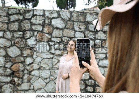 Mobile photography.Portrait of beautiful sweet girls with smartphone.Concept.-Modern and popular photography.-Image