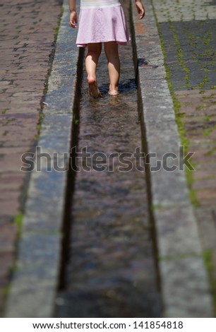 child walking through canal in freiburg 