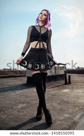 Portrait of lovely gothic girl on the roof. Pastel goth with violet (pink) hair in black clothes Royalty-Free Stock Photo #1418550395