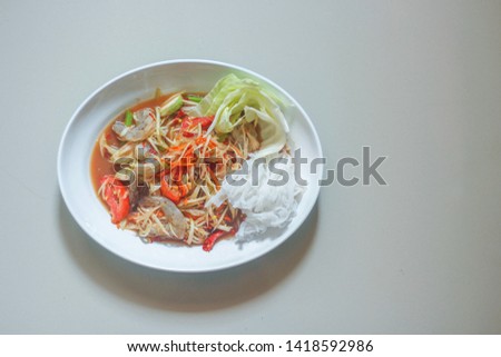 Papaya salad in fish sauce with raw shrimp.