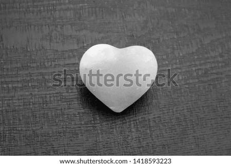 heart shaped rock salt in a black background