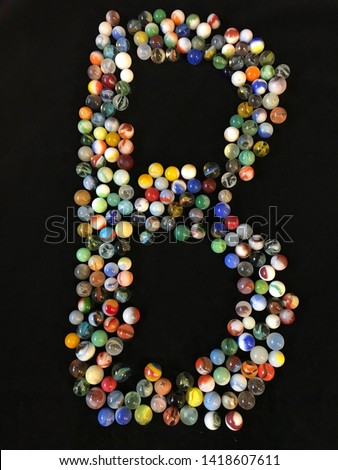 letter alphabet of various multicolored balls isolated on black
