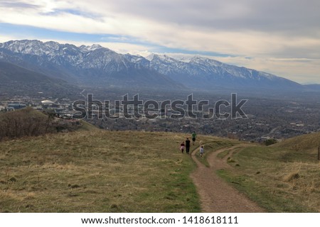Family on a stroll in the foothills of the Wasatch enjoying views of downtown Salt Lake City