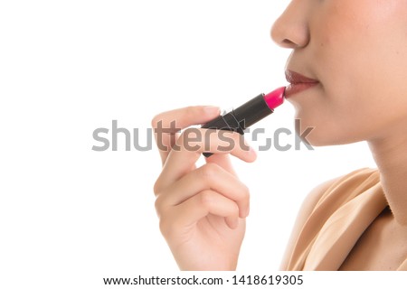 Closeup asian woman are making up by lipstick free from copy space on white background.
