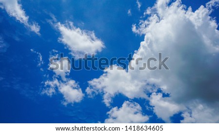 Blue sky and white giant clouds, background and free space.