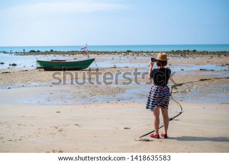 Asian woman taking photo on the beach, Thaialnd