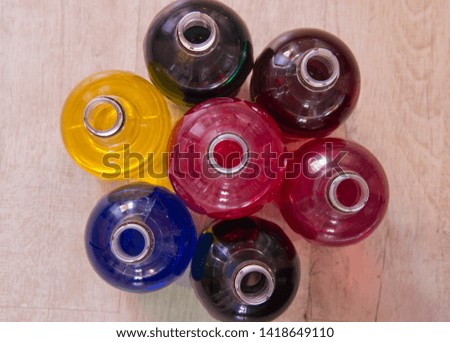 Plastic bottles filled with liquid of different colors.