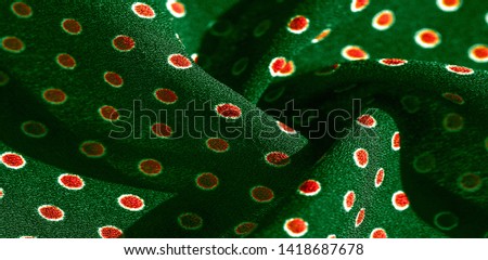 Texture background, pattern,  green silk fabric with red polka dots.