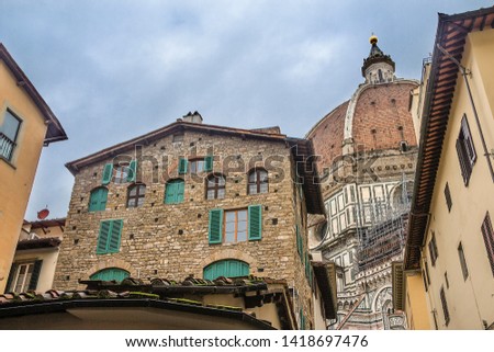 Italy, Florence. Residential buildings on the background of the dome of the Cathedral of Santa Maria del Fiore, located in the heart of the city, on the Cathedral Square.