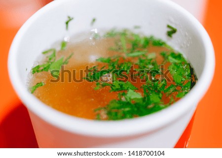 fresh soup in a carton a to-go Cup closeup