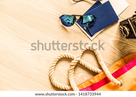 Flat lay traveler accessories on yellow background with palm leaf, camera and sunglasses. Top view travel or vacation concept. Summer background