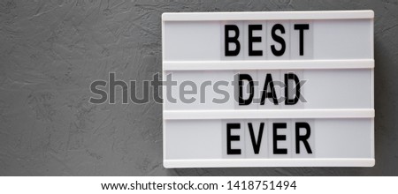 Lightbox with 'Best dad ever' words over gray surface, top view. Overhead, from above, flat lay. Copy space.