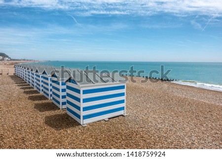 beach huts on Hastings beach in Sussex England Royalty-Free Stock Photo #1418759924