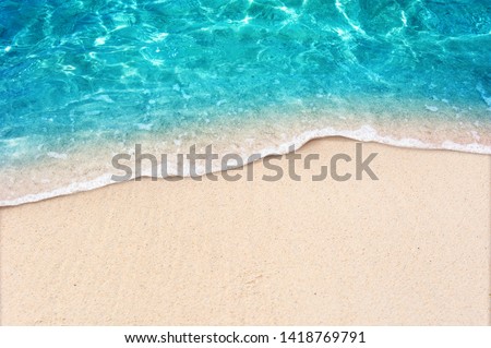 Soft blue ocean wave on clean sandy beach Royalty-Free Stock Photo #1418769791