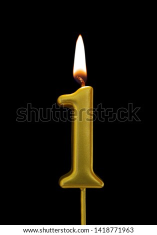 Burning birthday golden candle isolated on black background, number 1 Royalty-Free Stock Photo #1418771963