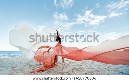 Slim Woman at the beach with long pink fabric. Sky background at the summer. Classic dancer on the nature Royalty-Free Stock Photo #1418778836