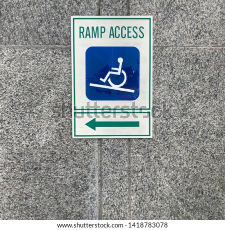 Ramp Access public information sign on marble wall