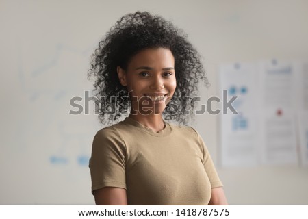 Head shot confident mixed race woman firm member having photo shoot in office, portrait of leader successful businesswoman smiling looking at camera. Corporate success, empowerment, leadership concept