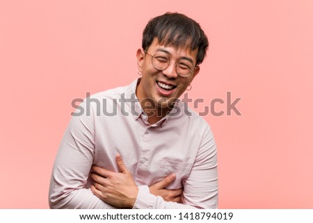 Young chinese man laughing and having fun