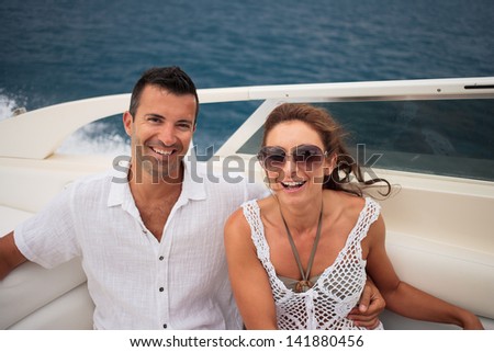 picture of happy young couple on their yacht