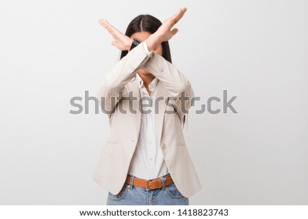 Young business arab woman isolated against a white background keeping two arms crossed, denial concept.