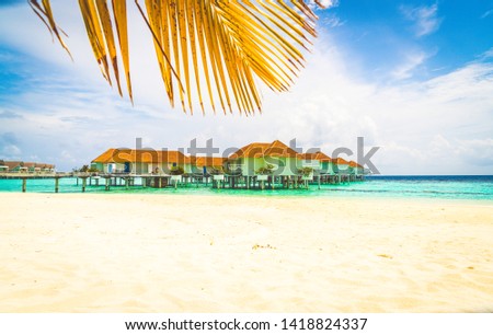 Beautiful tropical Maldives resort hotel and island with beach and sea - holiday vacation background concep