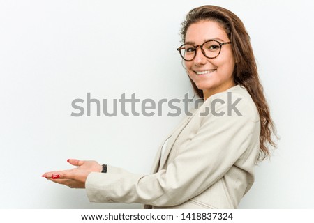 Young european business woman holding a copy space on a palm.