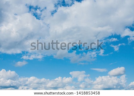 white clouds on a blue sky on a Sunny summer day.