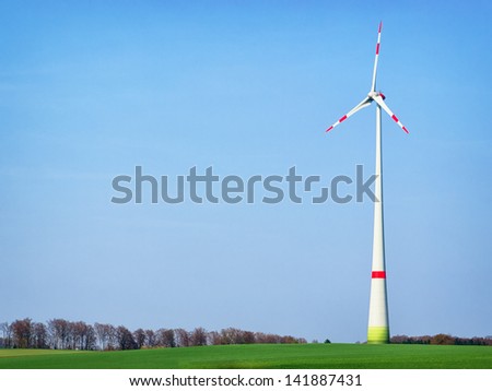modern wind generator in front of blue sky