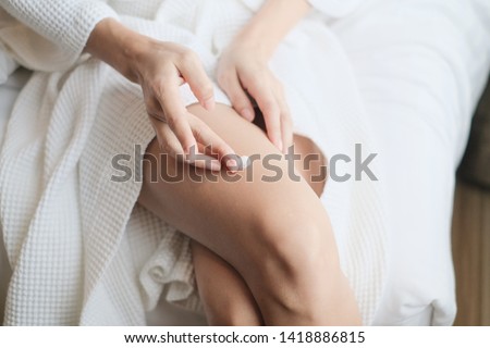 Woman applying legs cream,lotion , Hygiene skin body care concept. Royalty-Free Stock Photo #1418886815