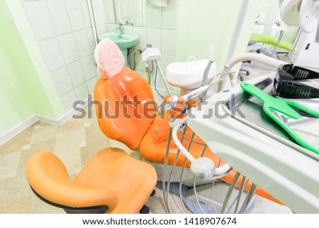 Medical interior, dental office with an orange chair, lamp and equipment. stomatology concept