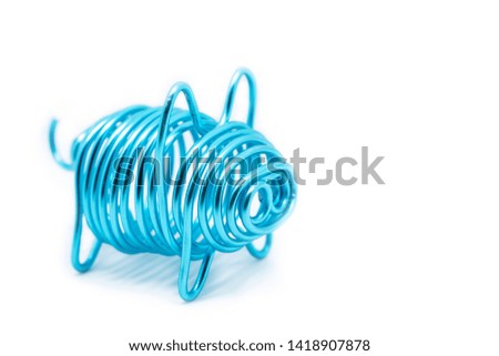 Selective focus picture of handmade Piggy made by aluminium wire with isolate white background and copy space, close up background