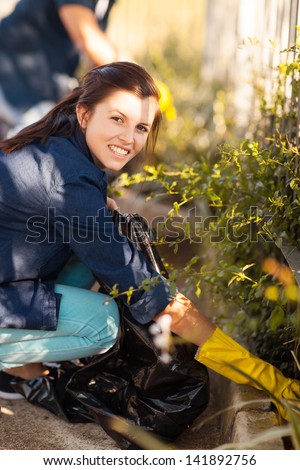 beautiful teenage girl and friends cleaning the streets Royalty-Free Stock Photo #141892756