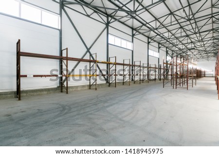 Interior of empty warehouse with empty racks	