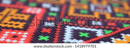 Traditional Ukrainian folk art knitted embroidery pattern on textile fabric