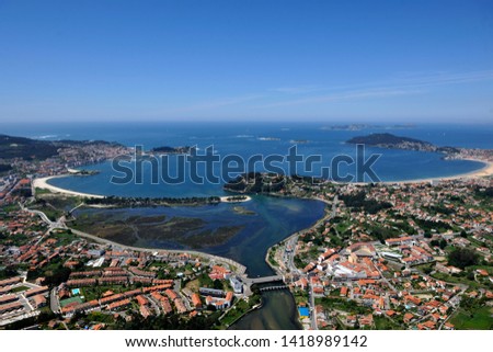 
aerial image of the coastal city of baiona in pontevedra, galicia