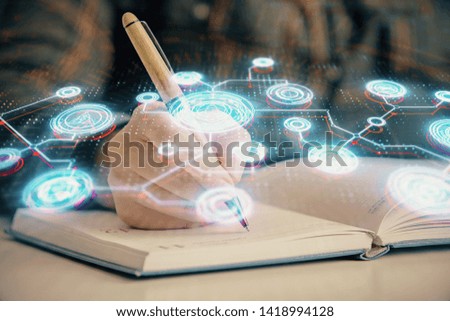 Social network theme hologram over hands taking notes background. Concept of global international people connect. Double exposure