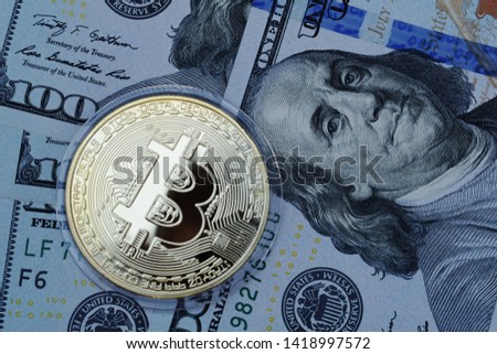 Golden Bitcoin on US dollars. Digital currency.