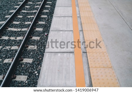 yellow tactile paving side train station for blind people