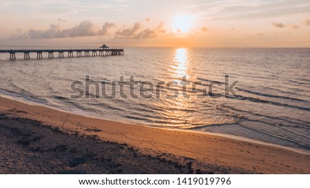 Fabulous sunrise on the beach and pier in Deerfield Beach, Florida, aerial view, drone photography