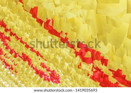 Yellow and red dense square flags fluttering in the wind on holiday celebrations