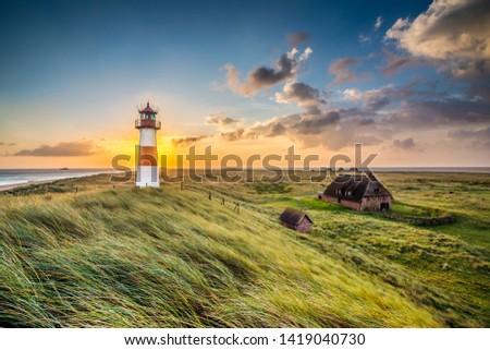 Sunrise at lighthouse in List on the island of Sylt, Schleswig-Holstein, Germany Royalty-Free Stock Photo #1419040730