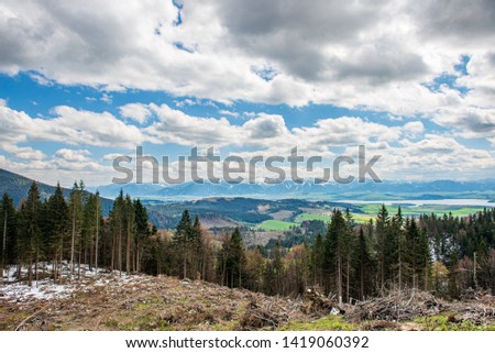 countryside landscape under blue sky and dramatic white clouds in summer
