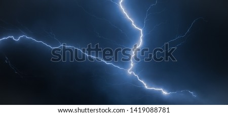 Branched lightning bolt high up in the sky, also known as an anvil crawler. Photographed at the back of a thunderstorm over northeastern Nebraska. Royalty-Free Stock Photo #1419088781