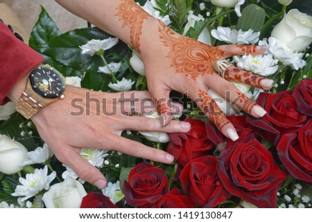 Hands of the bride and groom with rings 