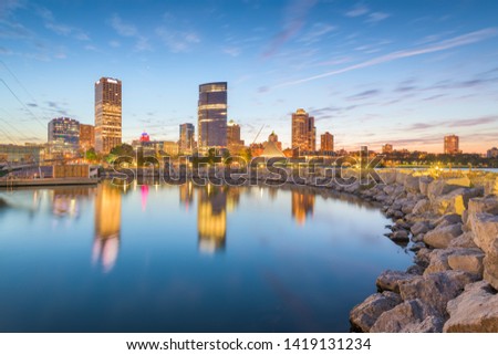 Milwaukee, Wisconsin, USA downtown city skyline on Lake Michigan at twilight. 