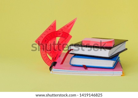 Back to school concept with space for text. Copy space. School office supplies.Creative desk with colourful stationery. Colored paper clip.School supplies on yellow background.Office desk.