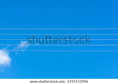 Empty music staff concept photo of 5 electric wires on blue sky, music creation template copy space